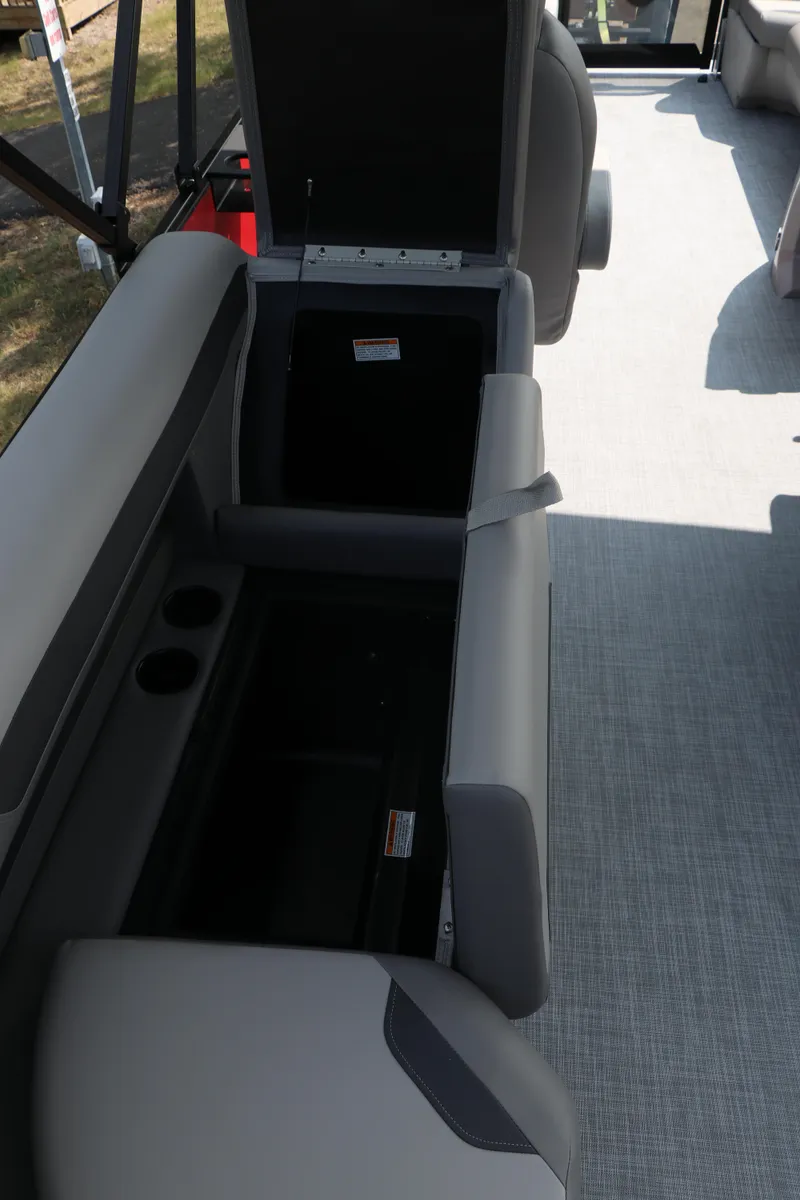 Slide: The Image of 2025 Premier 220 Sunscape boat interior with open storage compartments and seating. - 25