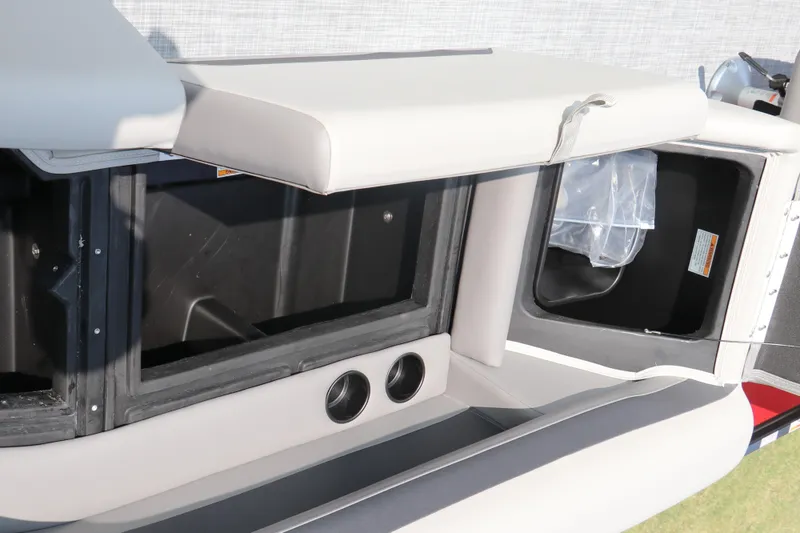 Slide: The Image of 2025 Premier 220 Sunscape boat interior storage compartments and seating area. - 26