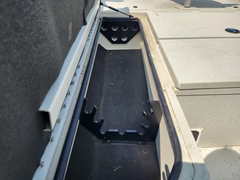 Slide: The Image of 2022 Ranger RB200 boat storage compartment with rod holders. - 10