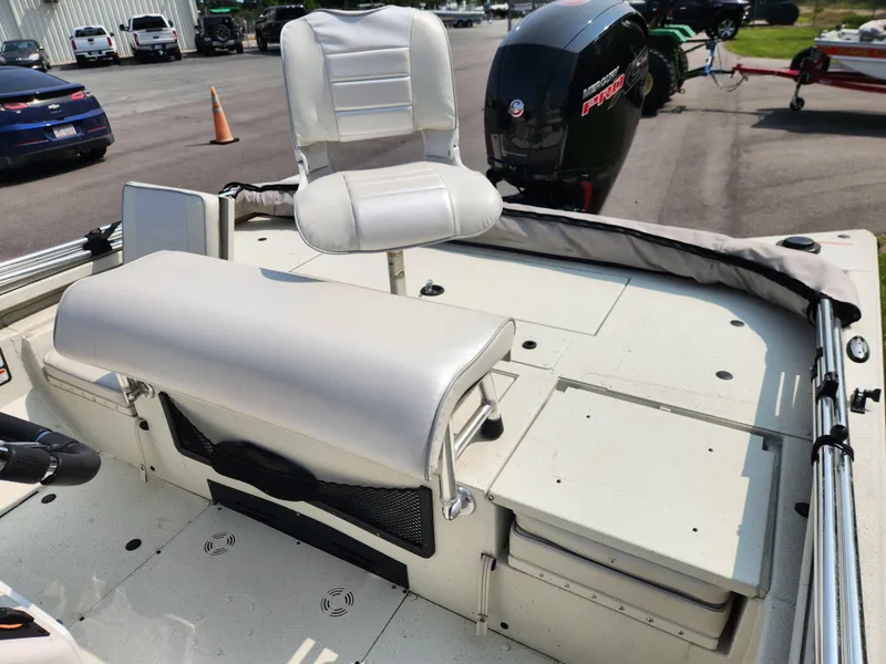 Slide: The Image of 2022 Ranger RB200 boat interior with white seating and motor in parking lot. - 12