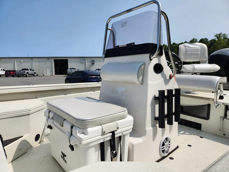 Slide: The Image of 2022 Ranger RB200 boat interior with seating and storage, parked outdoors. - 15