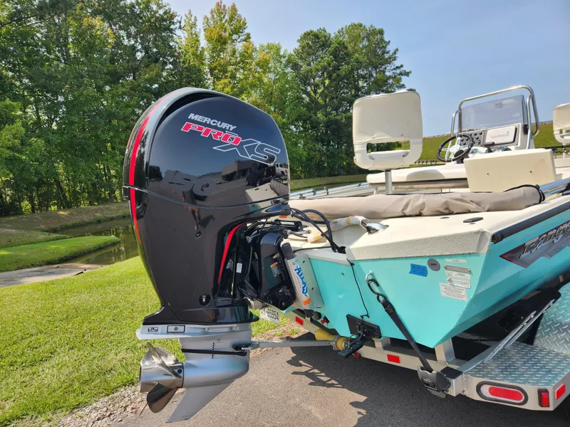 Slide: The Image of 2022 Ranger RB200 boat with Mercury Pro XS outboard motor, parked on grass. - 4