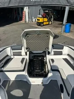 Slide: The Image of 2019 Yamaha SX195 boat engine compartment open, showcasing interior details. - 10