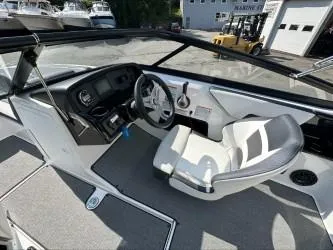 Slide: The Image of 2019 Yamaha Boats SX195 cockpit with steering wheel and controls, featuring modern design. - 16
