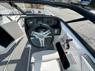Slide: The Image of 2019 Yamaha Boats SX195 cockpit with steering wheel and control panel. - 18