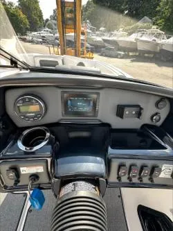Slide: The Image of 2019 Yamaha Boats SX195 dashboard with controls and display, parked outdoors. - 19
