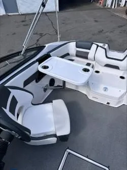 Slide: The Image of 2019 Yamaha Boats SX195 interior with seating and table setup. - 21