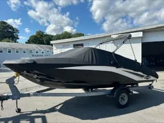 Slide: The Image of 2019 Yamaha SX195 boat on trailer, covered, outdoors under blue sky. - 29