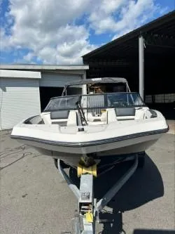 Slide: The Image of 2019 Yamaha Boats SX195 on trailer, parked outdoors under a partly cloudy sky. - 3