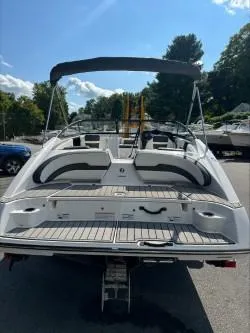 Slide: The Image of 2019 Yamaha Boats SX195, rear view, sleek design, outdoor setting, sunny day. - 6