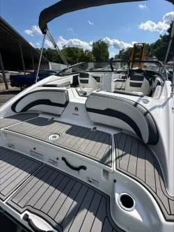 Slide: The Image of 2019 Yamaha Boats SX195 with sleek seating and spacious deck under a sunny sky. - 8