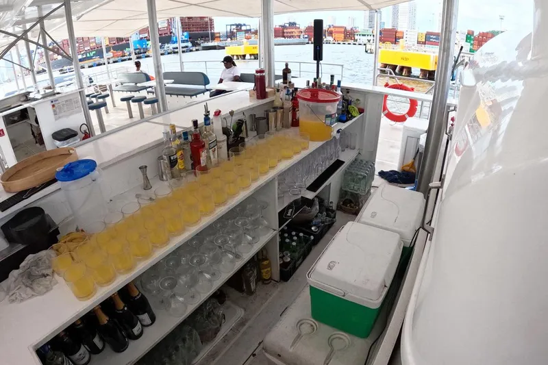 Slide: The Image of Boat bar setup with drinks and glasses on a 2024 Custom PaxCat 80. - 15