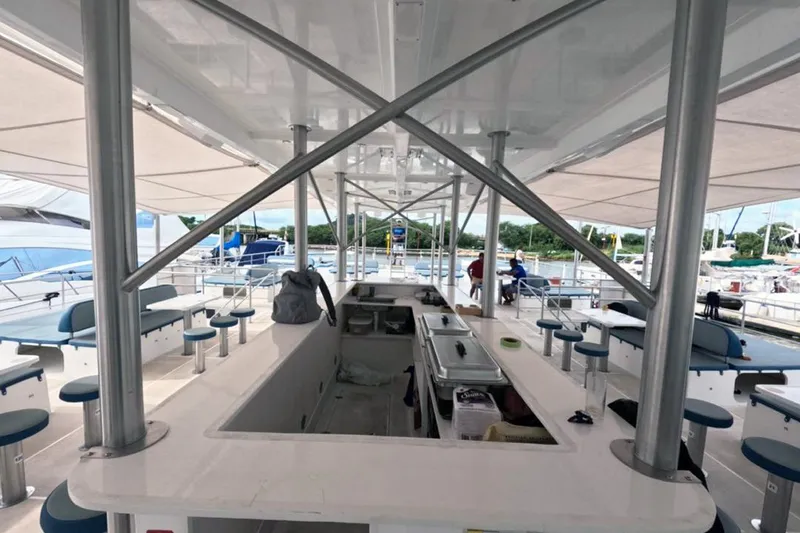 Slide: The Image of Spacious deck of 2024 Custom PaxCat 80 with seating and bar area. - 16