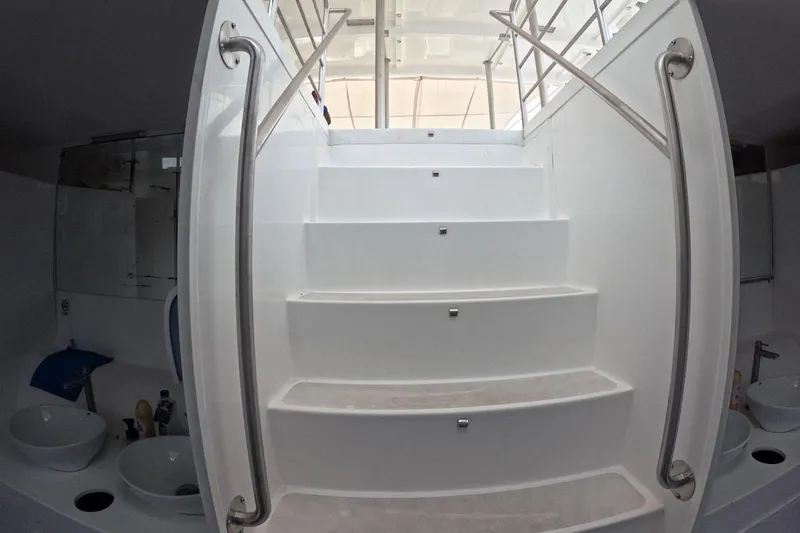 Slide: The Image of White staircase with metal railings inside a 2024 Custom PaxCat 80 yacht. - 20