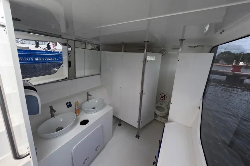 Slide: The Image of Interior of 2024 Custom PaxCat 80 boat with dual sinks and restroom facilities. - 21