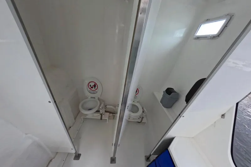 Slide: The Image of Custom PaxCat 80 boat restroom with dual toilets, 2024 model. - 22