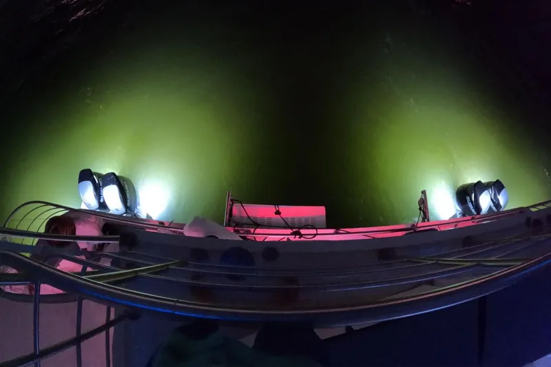 Slide: The Image of Custom PaxCat 80 boat with underwater lights illuminating green water, 2024 model. - 3