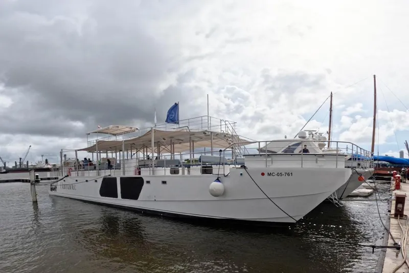 Slide: The Image of Custom PaxCat 80 boat docked at marina, 2024 model, under cloudy sky. - 4