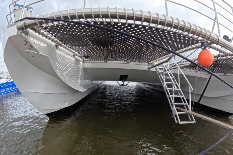 Slide: The Image of Custom PaxCat 80 catamaran, 2024 model, docked with visible netting and ladder. - 6