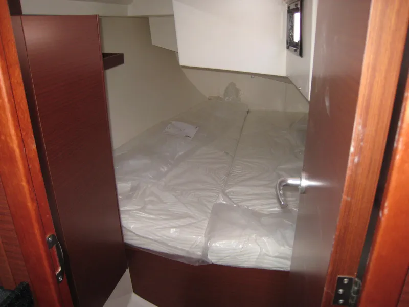 Slide: The Image of Cabin interior of 2025 Hanse 348 yacht with a neatly made bed. - 3