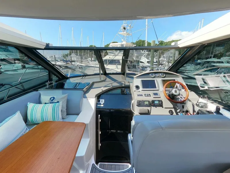 Slide: The Image of Interior view of 2011 Regal 42 Sport Coupe yacht with helm and seating area. - 10