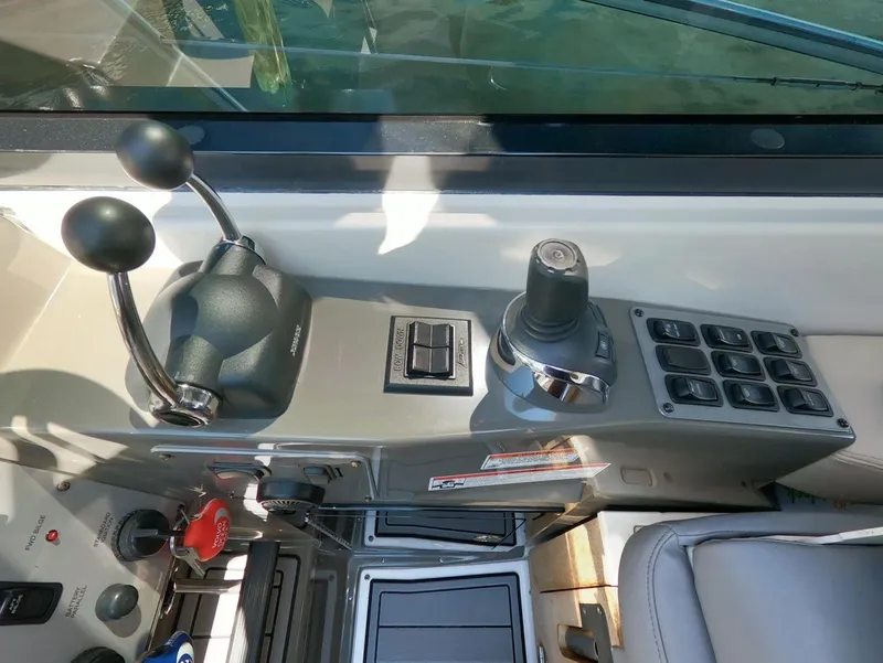 Slide: The Image of Control panel of 2011 Regal 42 Sport Coupe boat with throttle and joystick. - 16