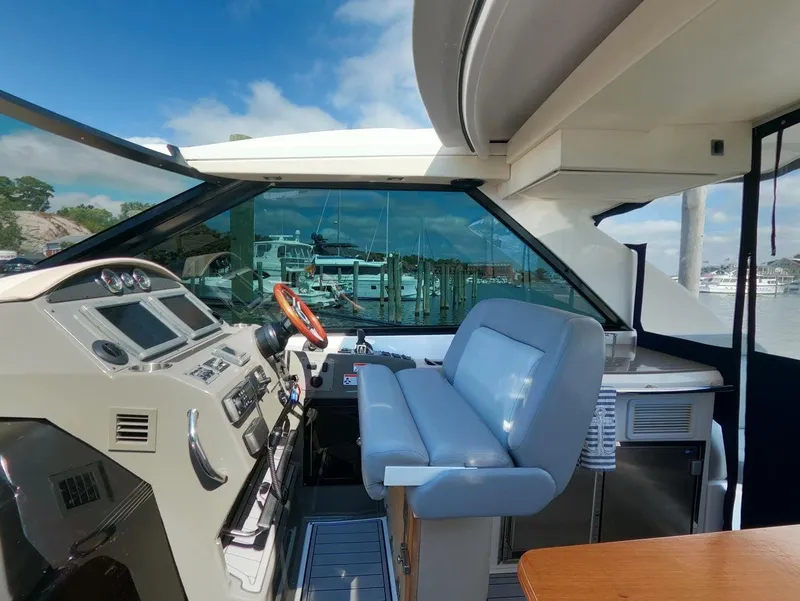 Slide: The Image of Interior of 2011 Regal 42 Sport Coupe yacht with modern helm and seating. - 17