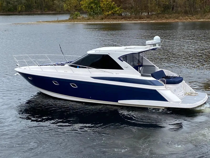 Slide: The Image of 2011 Regal 42 Sport Coupe cruising on a serene lake. - 2