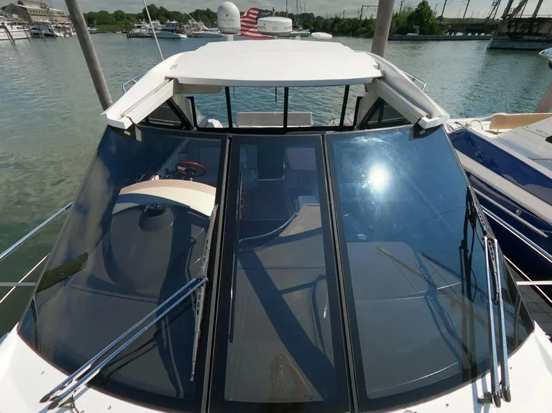 Slide: The Image of 2011 Regal 42 Sport Coupe yacht with sleek windshield design on calm water. - 20