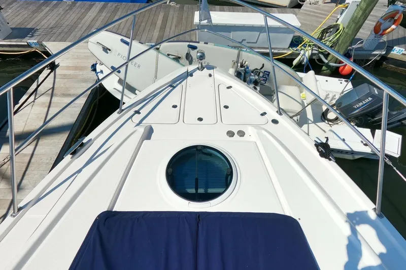 Slide: The Image of 2011 Regal 42 Sport Coupe yacht bow view at marina. - 21