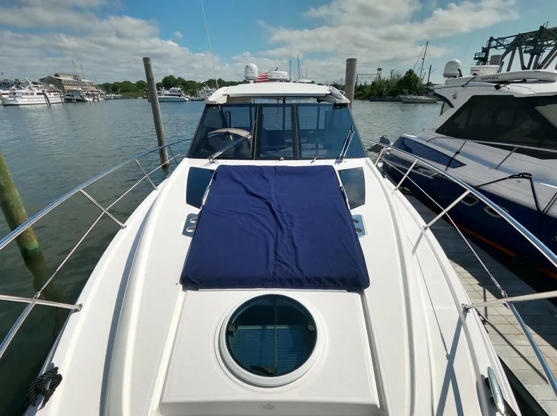Slide: The Image of 2011 Regal 42 Sport Coupe yacht docked at marina under blue sky. - 22