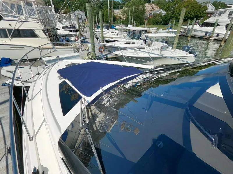 Slide: The Image of 2011 Regal 42 Sport Coupe docked among other boats in a marina. - 24