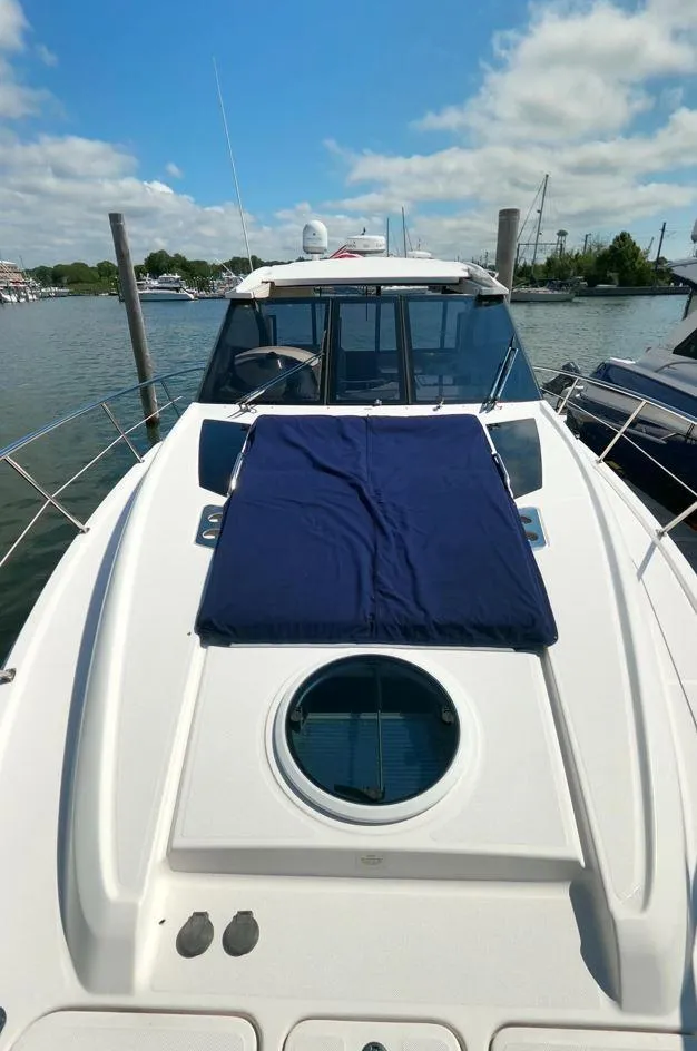 Slide: The Image of 2011 Regal 42 Sport Coupe yacht with sunpad, docked on a sunny day. - 25