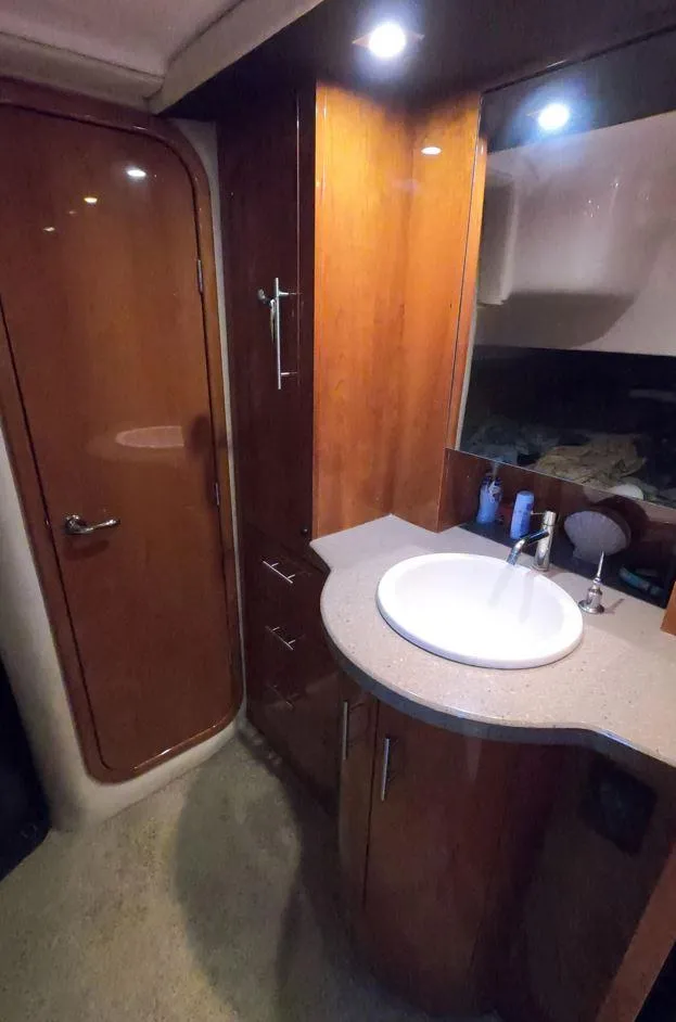 Slide: The Image of 2011 Regal 42 Sport Coupe bathroom with wood cabinetry and modern sink. - 37