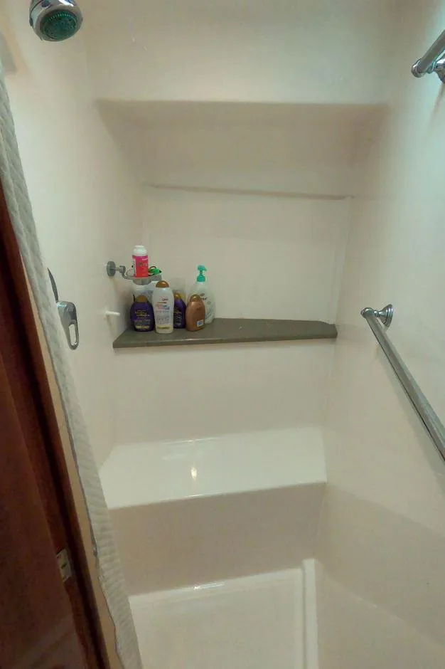 Slide: The Image of Shower area in 2011 Regal 42 Sport Coupe with toiletries on shelf. - 39