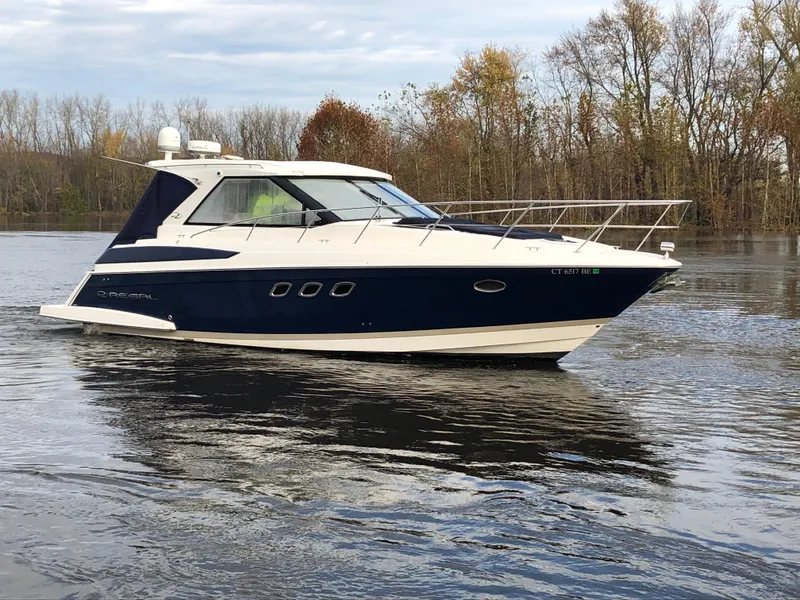 Slide: The Image of 2011 Regal 42 Sport Coupe cruising on a calm lake. - 44