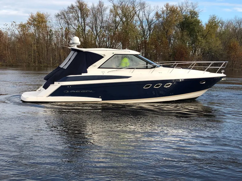 Slide: The Image of 2011 Regal 42 Sport Coupe cruising on a calm lake with autumn trees in the background. - 46