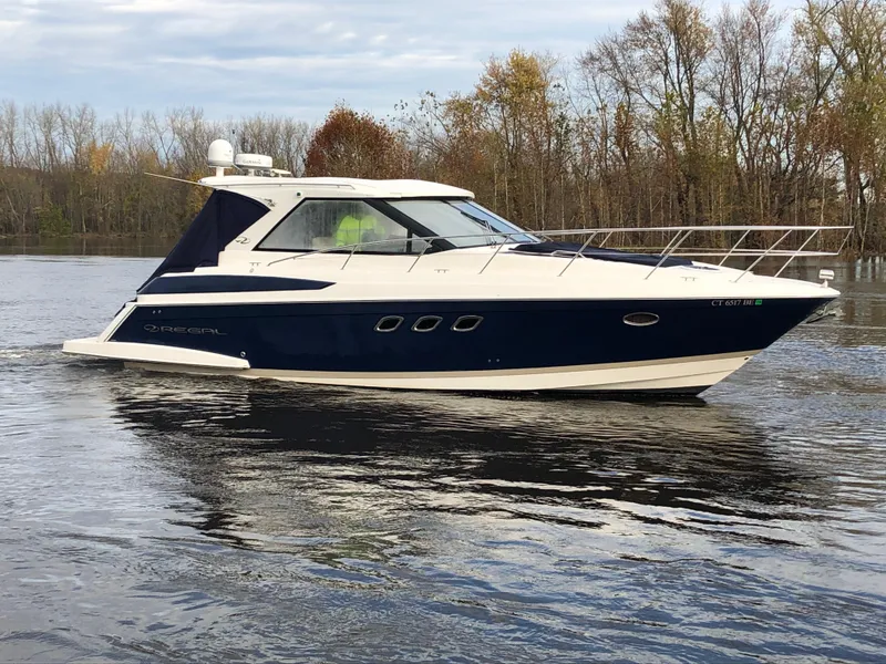 Slide: The Image of 2011 Regal 42 Sport Coupe cruising on a calm lake with autumn trees in the background. - 47