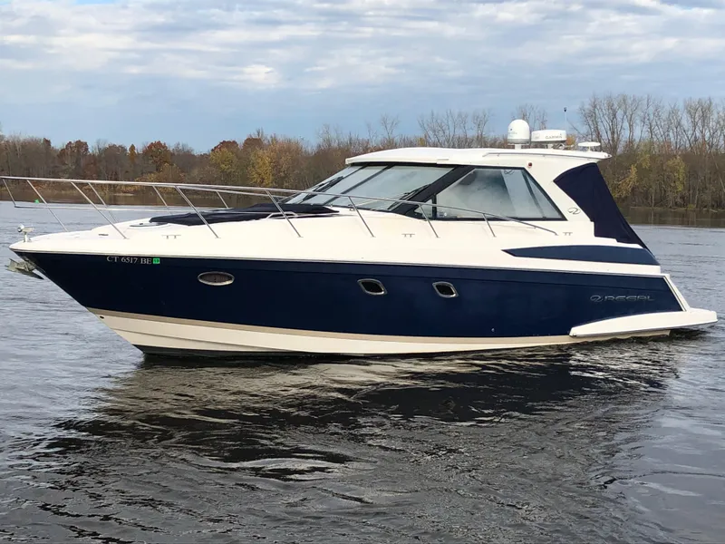 Slide: The Image of 2011 Regal 42 Sport Coupe yacht on calm water, showcasing sleek design and luxury features. - 48