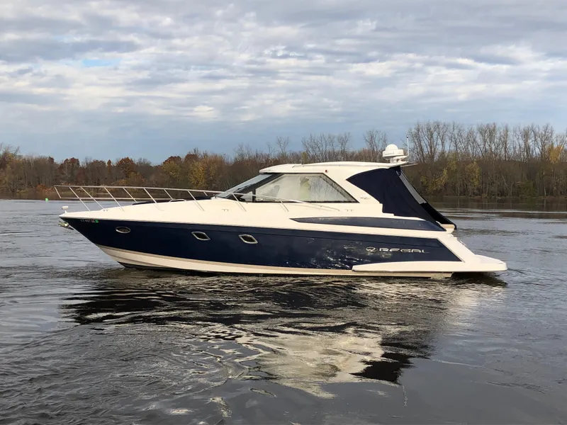 Slide: The Image of 2011 Regal 42 Sport Coupe yacht cruising on a calm river. - 49