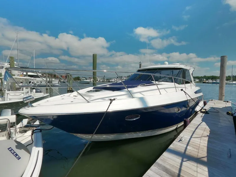 Slide: The Image of 2011 Regal 42 Sport Coupe yacht docked at marina under blue sky. - 6