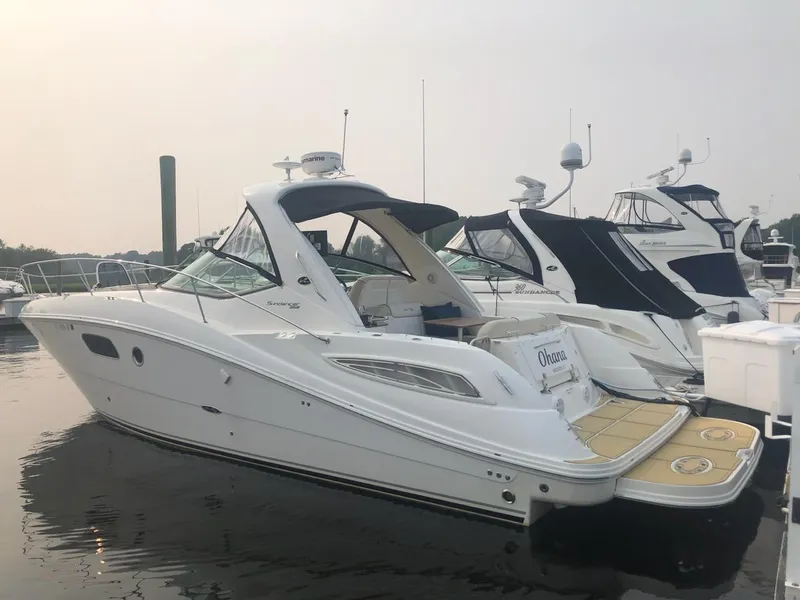Slide: The Image of 2012 Sea Ray 350 Sundancer yacht docked at marina, side view. - 2