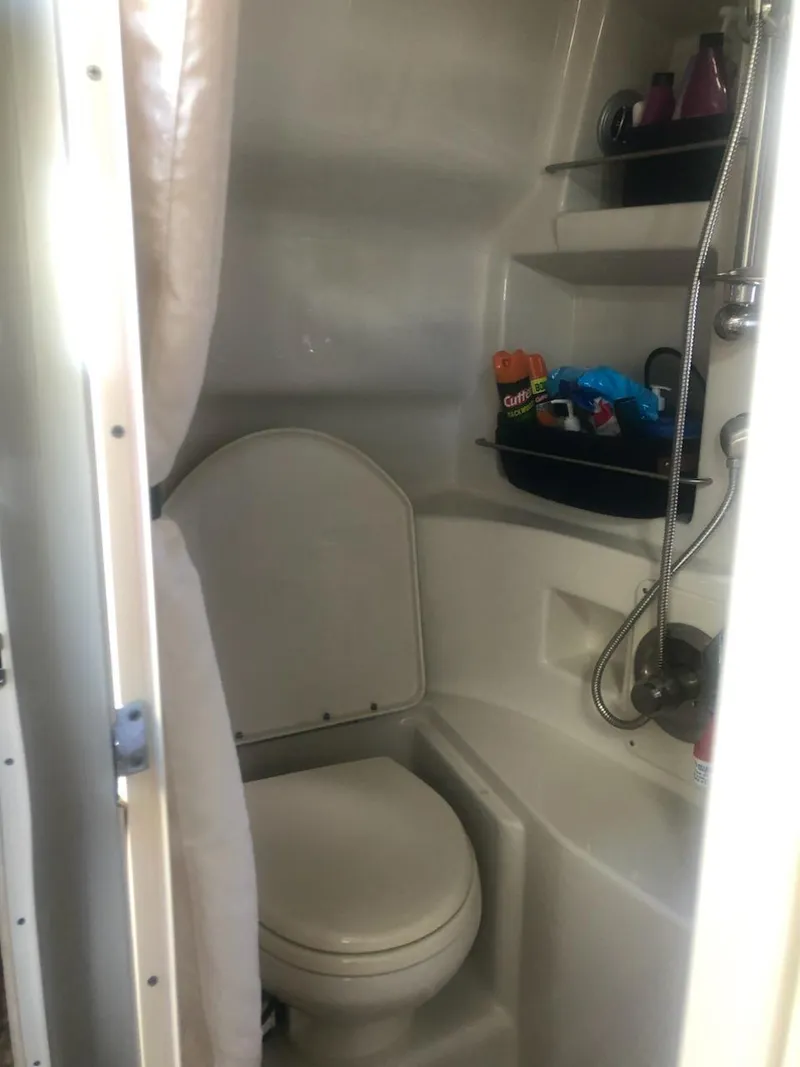 Slide: The Image of 2012 Sea Ray 350 Sundancer bathroom with toilet and shower. - 8