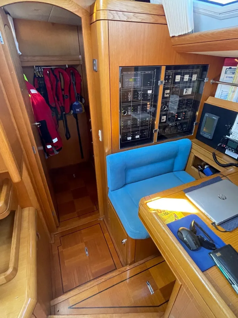 Slide: The Image of Interior of 2003 Oyster 53 yacht with navigation station and storage area. - 12
