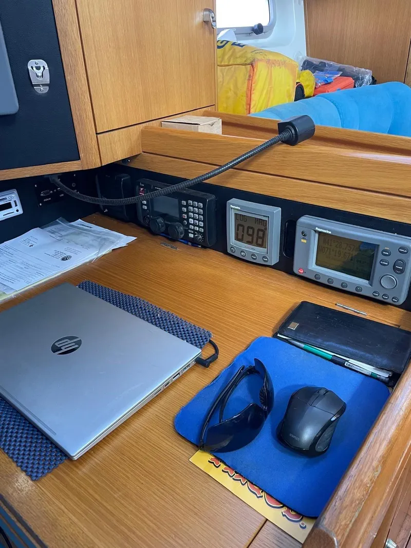 Slide: The Image of Navigation station on 2003 Oyster 53 yacht with electronics, laptop, and accessories. - 16