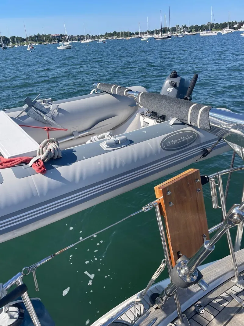 Slide: The Image of 2003 Oyster 53 yacht with inflatable dinghy on calm water. - 2