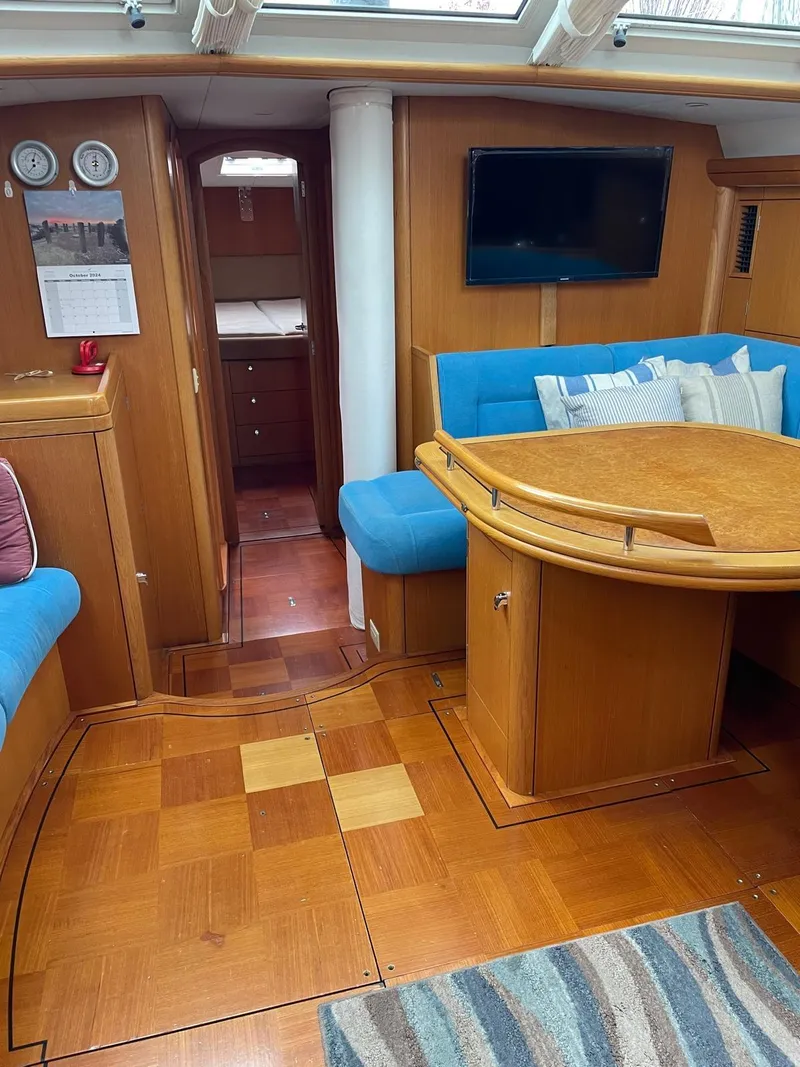 Slide: The Image of Interior of 2003 Oyster 53 yacht with wooden flooring and blue seating. - 20