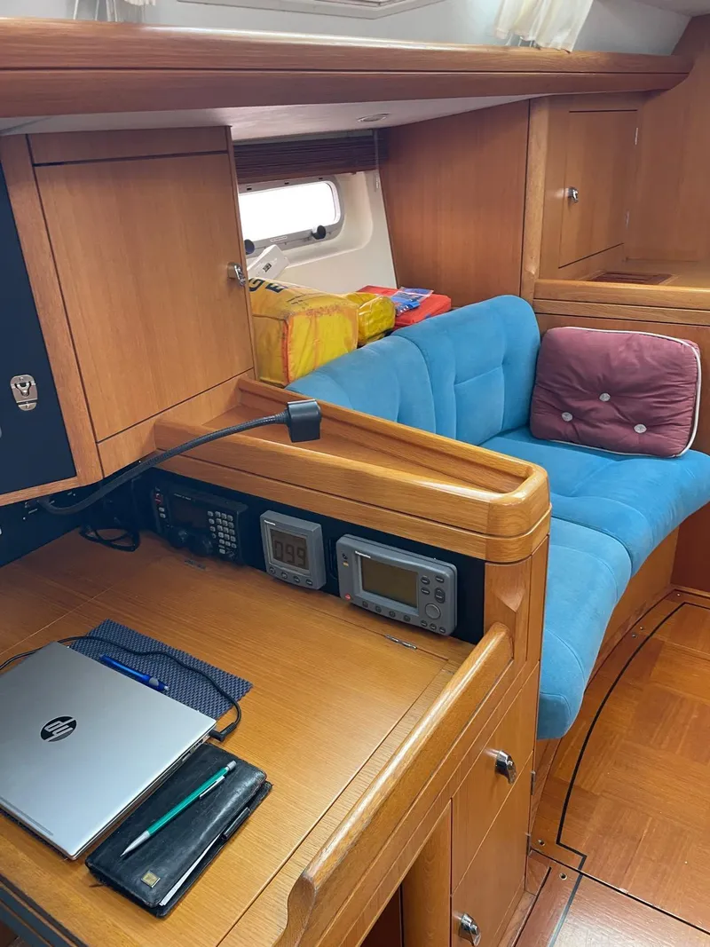 Slide: The Image of Interior of 2003 Oyster 53 yacht with navigation equipment and cozy seating area. - 21