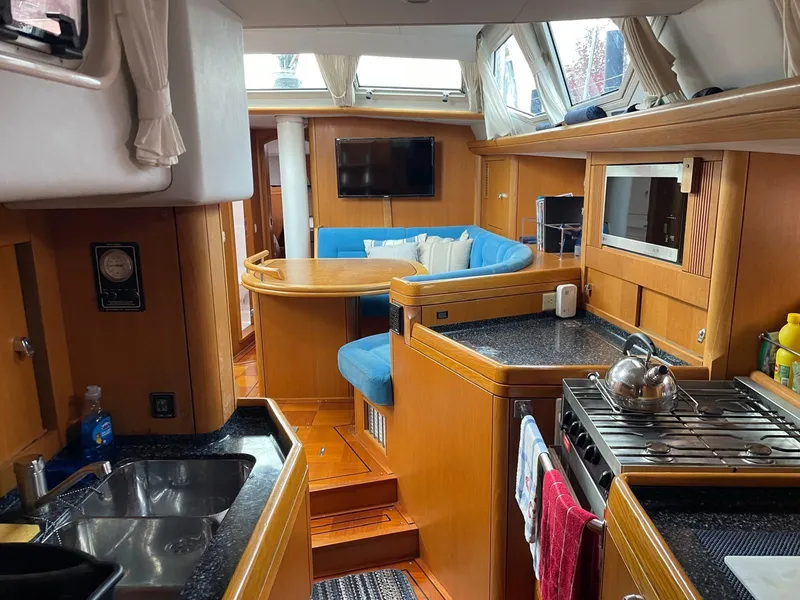Slide: The Image of Interior of 2003 Oyster 53 yacht with modern kitchen and cozy seating area. - 22