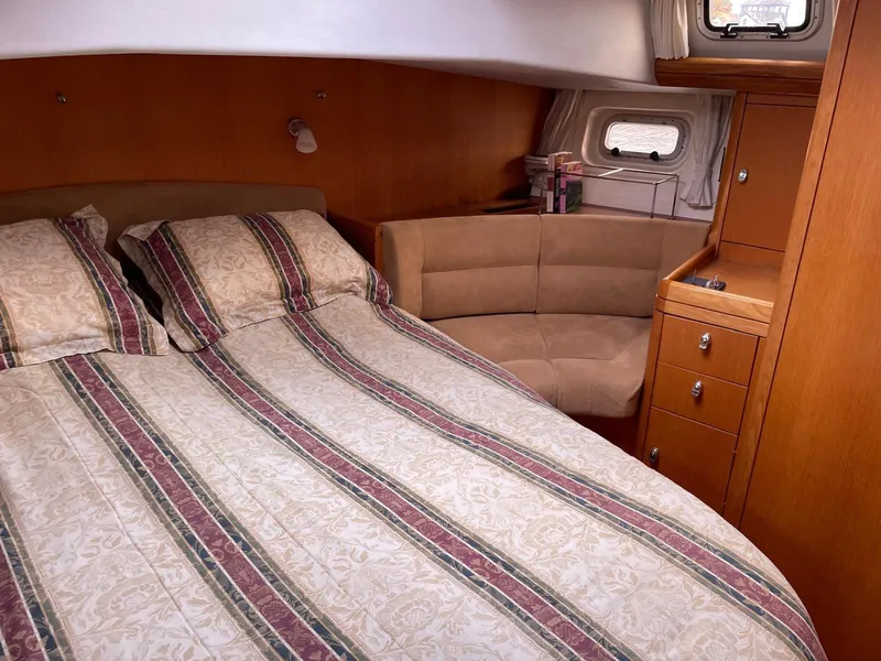 Slide: The Image of Cozy cabin interior of 2003 Oyster 53 yacht with double bed and seating area. - 25